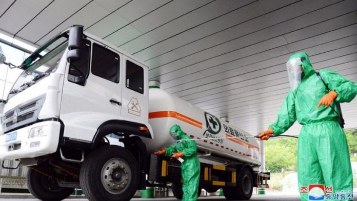 A worker disinfects a vehicle carrying medical oxygen, in Pyongyang-754x424 (Copy)