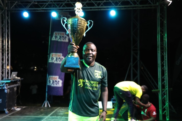 Dr Poundz lifting his trophy after winning Hits FM rep ur jersey