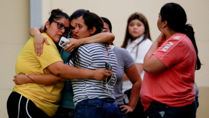 Relatives of children at the school gathered at a nearby civic centre to wait for news REUTERS