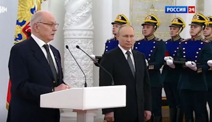 Putin stands to one side as he shakes uncontrollably ( Image: Russia-1) Putin stands to one side as he shakes uncontrollably ( Image: Russia-1)