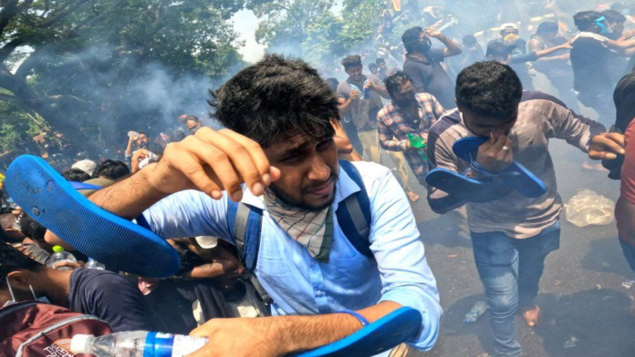 Police had fired tear gas at protesters who attempted to break down the gates of the prime minister's office in Colombo/ Photo credit: Getty Images Police had fired tear gas at protesters who attempted to break down the gates of the prime minister's office in Colombo/ Photo credit: Getty Images