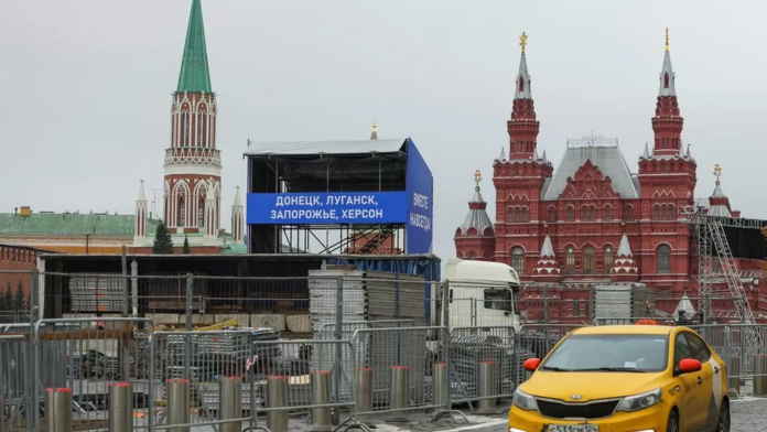 A stand has been erected at Red Square before the speech displaying the names of the regions to be annexed