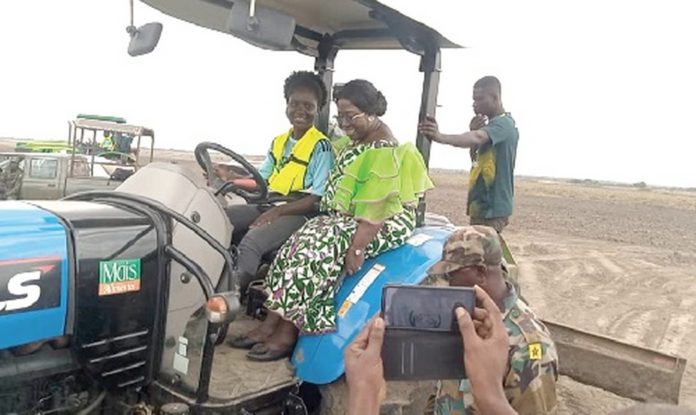 Akosua Frema Osei-Opare, Chief of Staff, being offered a ride on a tractor after the launch_1680x1001