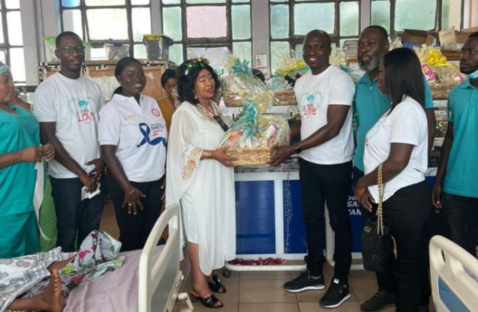 Francis Gota, aYo Ghana CEO presenting items to new mothers at KATH