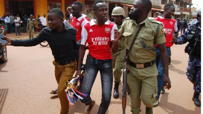 One fan was carrying a symbolic trophy which they had bought at a store JACOBS ODONGO SEAMAN One fan was carrying a symbolic trophy which they had bought at a store JACOBS ODONGO SEAMAN