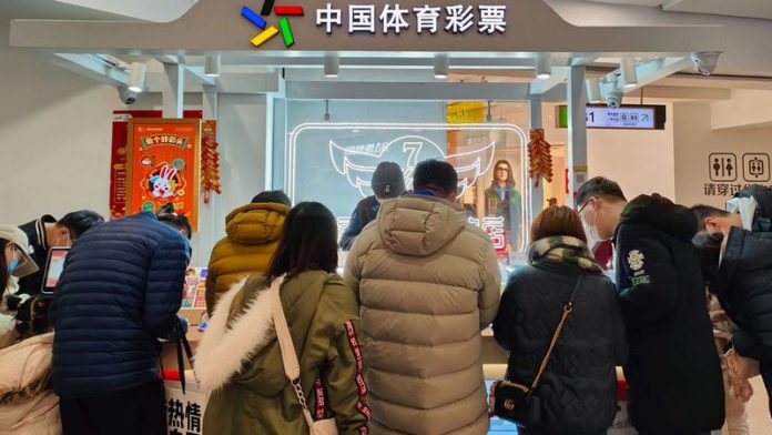 People buy tickets at the China Sports Lottery counter in Shanghai, China (Image: Future Publishing via Getty Images) People buy tickets at the China Sports Lottery counter in Shanghai, China (Image: Future Publishing via Getty Images)