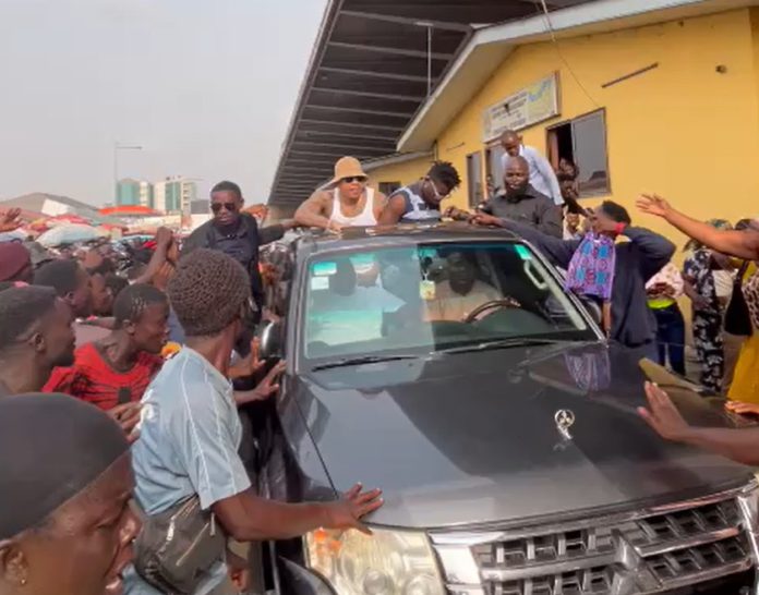 Kuami Eugene and Rotimi splash cash on Accra streets