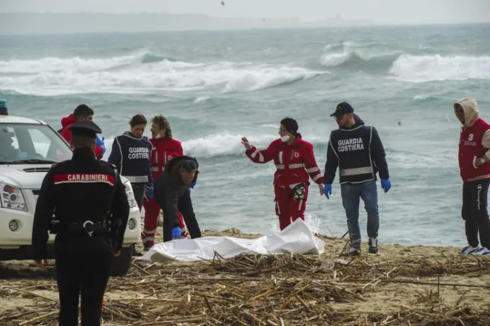 Italian Red Cross volunteers and coast guards recover a body after a migrant boat broke apart in rough seas, at a beach near Cutro, southern Italy, on Feb. 26, 2023. AP/Antonino Durso/LaPress Italian Red Cross volunteers and coast guards recover a body after a migrant boat broke apart in rough seas, at a beach near Cutro, southern Italy, on Feb. 26, 2023. AP/Antonino Durso/LaPress