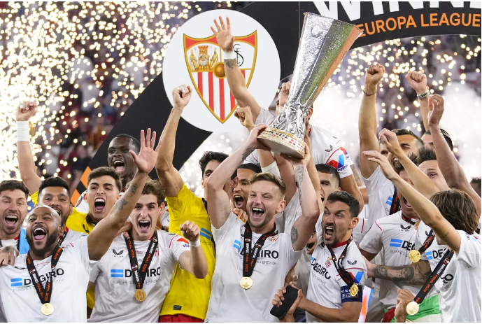 Sevilla’s team captain Ivan Rakitic lifts the trophy after winning the Europa League final soccer match between Sevilla and Roma, at the Puskas Arena in Budapest, Hungary, Wednesday, May 31, 2023. Sevilla defeated Roma 4-1 in a penalty shootout after the match ended tied 1-1. (AP Photo/Petr David Josek)(Petr David Josek / Associated Press) Sevilla’s team captain Ivan Rakitic lifts the trophy after winning the Europa League final soccer match between Sevilla and Roma, at the Puskas Arena in Budapest, Hungary, Wednesday, May 31, 2023. Sevilla defeated Roma 4-1 in a penalty shootout after the match ended tied 1-1. (AP Photo/Petr David Josek)(Petr David Josek / Associated Press)
