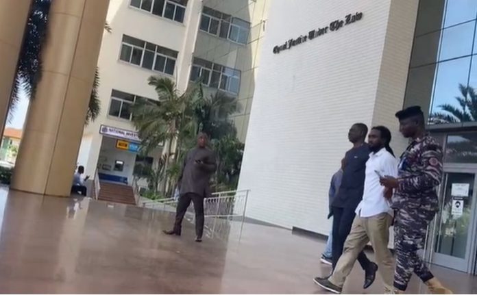 Bismark Ato Foster (in white shirt) being led away from the court by Police Bismark Ato Foster (in white shirt) being led away from the court by Police
