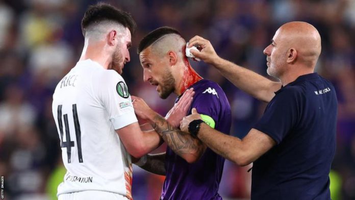 Fiorentina's Cristiano Biraghi needed treatment for a wound to the head after he struck by an object thrown from the stands during Wednesday's Europa Conference League final Fiorentina's Cristiano Biraghi needed treatment for a wound to the head after he struck by an object thrown from the stands during Wednesday's Europa Conference League final
