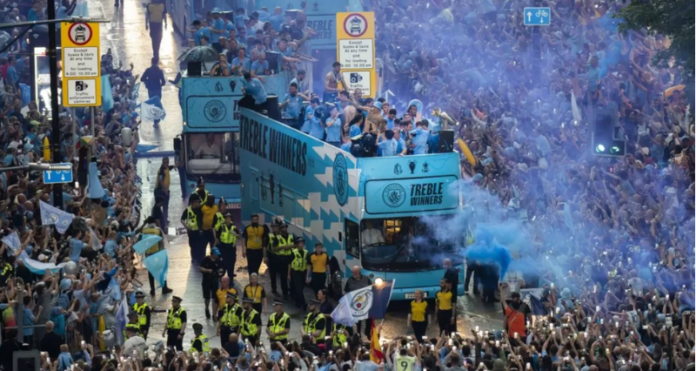 PA MEDIA Image caption: The parade was delayed by heavy rain and lightning but tens of thousands of fans turned out PA MEDIA Image caption: The parade was delayed by heavy rain and lightning but tens of thousands of fans turned out