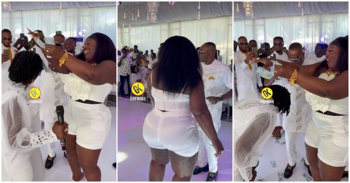 Akosua Agyepong was sprayed with cash by Mama Dollars. Image Credit: @ghkwaku Akosua Agyepong was sprayed with cash by Mama Dollars. Image Credit: @ghkwaku