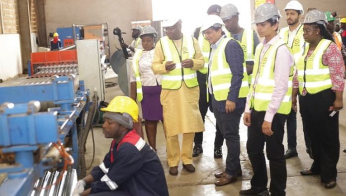 K.T. Hammond (arrowed), Minister of Trade and Industry, observing the production process at the company during the visit_1680x952