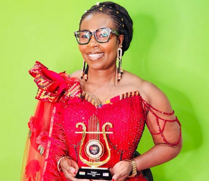 Mz Nana shows off her Ghana Music Awards USA plaque after her song, 'Oma Ne Nsa So,' won Gospel Song of the Year