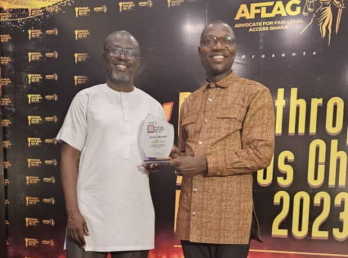 Abdulai Awudu, General Manager, Adom Brands, (left) and Fiifi Koomson, Ag. General Manager, Joy Brands, display the plaque that symbolises the honour done MGL. (1)