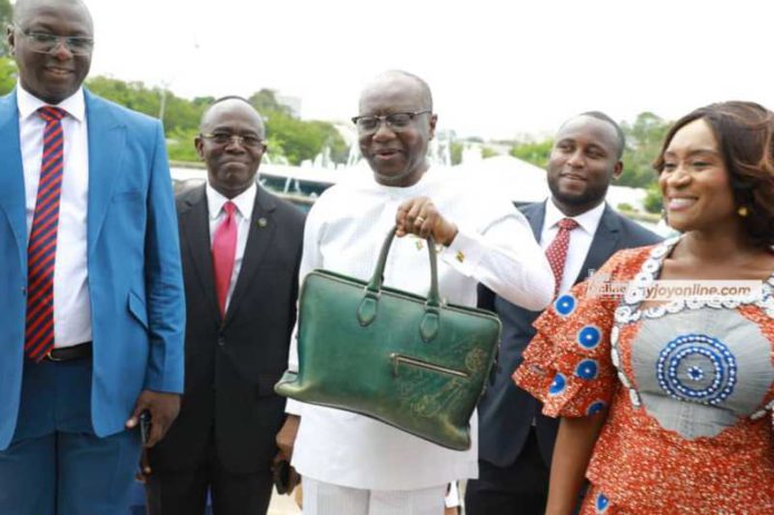 Ken Ofori-Atta (with green bag)