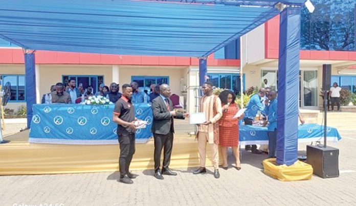 GSA (Copy) Prof. Alex Dodoo (2nd from left), Director-General, GSA, presenting a certificate to Atteh Adamtey, a certified electrical wiring professional, at the graduation ceremony
