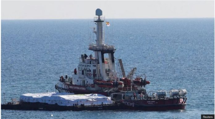 The Open Arms set sail from Larnaca on Tuesday morning, towing a barge filled with food aid.