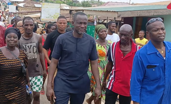 Eugene Arhin cuts sod for