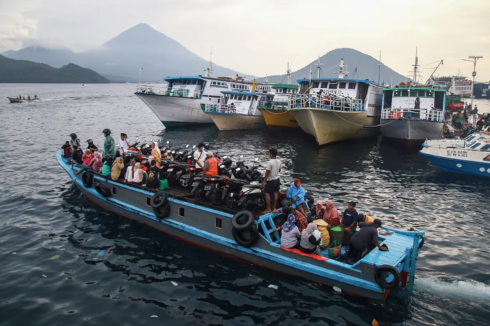 People travel on a wooden boat with motor scooters to Tidore Island ahead of Eid al-Fitr, which marks the end of the Muslim fasting month of Ramadan, at Bastiong port in Ternate, North Maluku, on 7 April 2024. Azzam Risqullah / AFP People travel on a wooden boat with motor scooters to Tidore Island ahead of Eid al-Fitr, which marks the end of the Muslim fasting month of Ramadan, at Bastiong port in Ternate, North Maluku, on 7 April 2024. Azzam Risqullah / AFP
