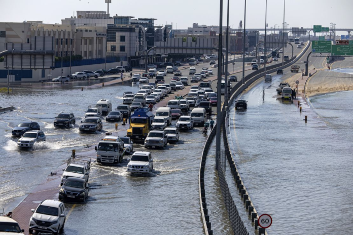 Vehicles drive through floodwater caused by heavy rain in Dubai on Thursday. Christopher Pike/AP Vehicles drive through floodwater caused by heavy rain in Dubai on Thursday. Christopher Pike/AP