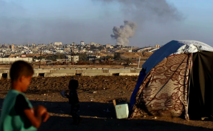Smoke rises following an Israeli airstrike on buildings near the separating wall between Egypt and Rafah, southern Gaza Strip.CREDIT:RAMEZ HABBOUB