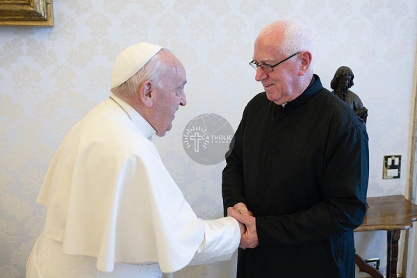 Fr. Andrew Campbell (right) in a warm handshake with is Holiness Pope Francis