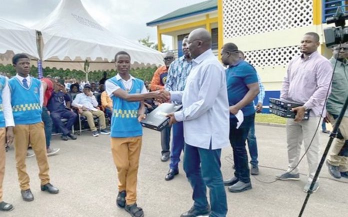 Dr Bawumia presenting a tablet to one of the students Dr Bawumia presenting a tablet to one of the students
