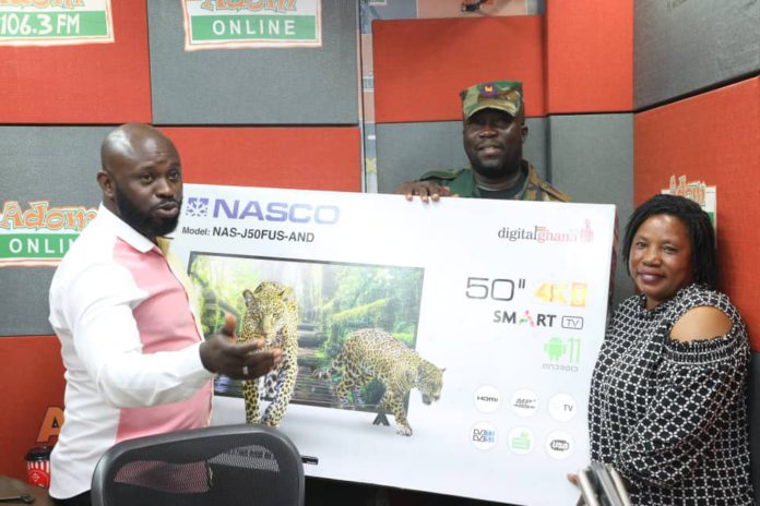Adom FM Presenter Ampofo Adjei presenting 50” smart android NASCO TV to Christiana Oduman in 1st monthly draw Adom FM Presenter Ampofo Adjei presenting 50” smart android NASCO TV to Christiana Oduman in 1st monthly draw