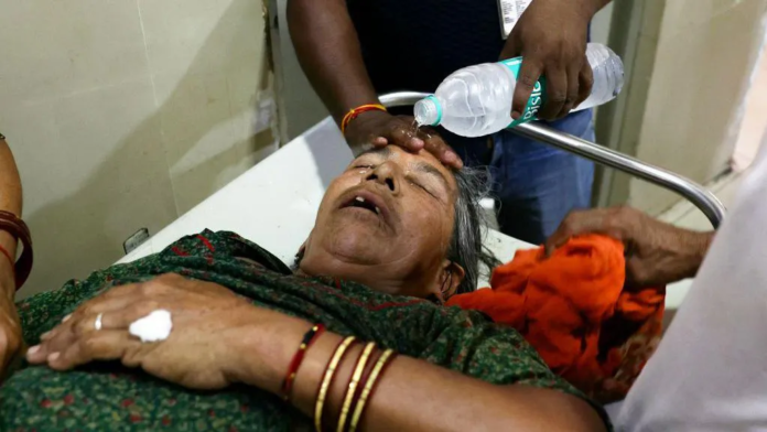 A staff member pours water on the face of a patient suffering from heat stroke in a hospital in Varanasi A staff member pours water on the face of a patient suffering from heat stroke in a hospital in Varanasi