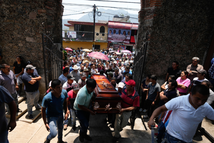 People carry a coffin that contains the remains of a man slain in a mass shooting into a church for a funeral service in Huitzilac, Mexico, on May 14. Fernando Llano/AP People carry a coffin that contains the remains of a man slain in a mass shooting into a church for a funeral service in Huitzilac, Mexico, on May 14. Fernando Llano/AP