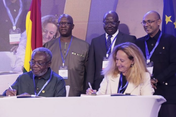 Dr Anthony Nsiah-Asare (left), Presidential Advisor on Health, and Myriam Ferran (right), Deputy Director-General, European Commission, signing the memorandum of understanding. Looking on are some officials. Picture: EDNA SALVO-KOTEY