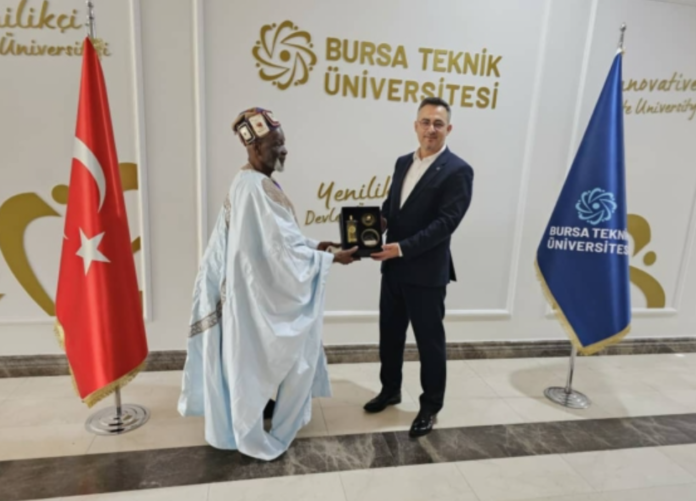Ya-Na Abukari II receiving a souvenir from Prof Dr. Naci Caglar, VC of Bursa Technical University in Bursa, Turkey after a co-operation meeting. Ya-Na Abukari II receiving a souvenir from Prof Dr. Naci Caglar, VC of Bursa Technical University in Bursa, Turkey after a co-operation meeting.