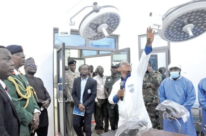 Dr Redeemer Seyram Fiebor, Head of HTU Clinic, conducting Major General Yusuf (2nd from left), Professor Ben Q. Honyenuga (left), Vice-Chancellor of HTU, and some guests and officials of the universit