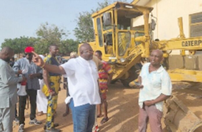 Mawutor Agbavitor (hand stretched), Volta Regional Chairman of the NDC, speaking at one of the sites (1)