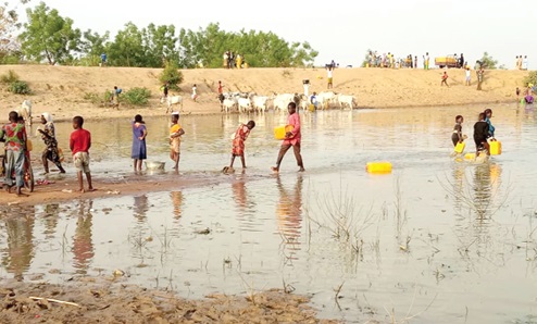 Residents sharing the polluted dam with animals