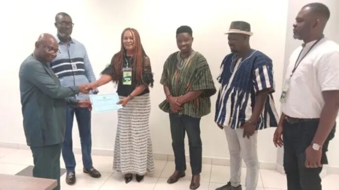 Madam Margaret O’Brien Sarfo of United 1 Ghana receiving Certificate from Mr. Benjamin Bano-Bioh, Director of Electoral Services of the EC