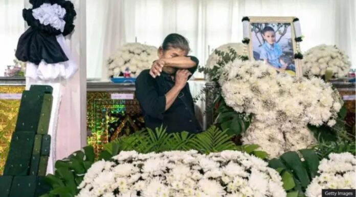 A mass funeral was held at the temple school which the victims attended.