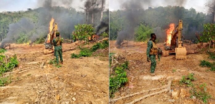 The excavators being burnt after the raid on illegal miners The excavators being burnt after the raid on illegal miners