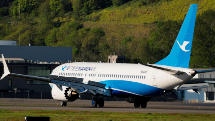 A Boeing 737 MAX 8 intended for a Chinese airline is returned to a Boeing airfield, as trade tensions escalate over US tariffs on Chinese imports