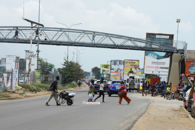 Pedestrians risk their lives crossing the road instead of using the newly constructed foot bridge at Tetegu Photo David Andoh