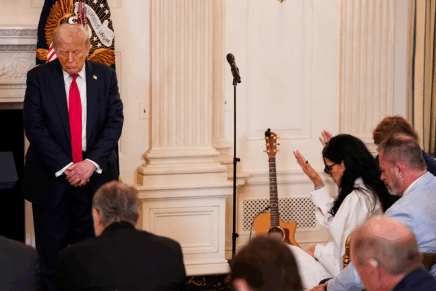 U.S. President Donald Trump prays with a group, during the White House Faith Office Luncheon at the White House in Washington, D.C.